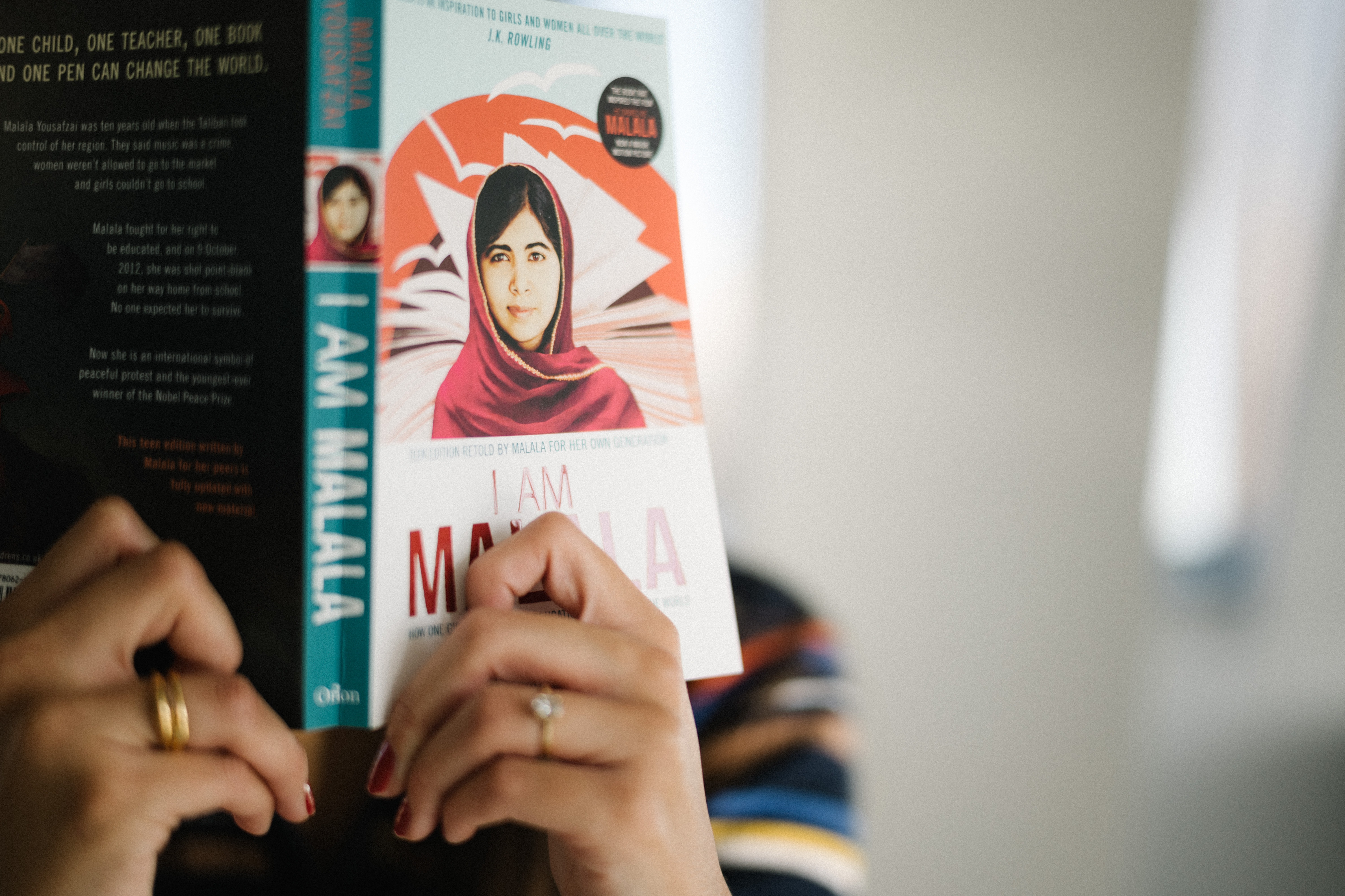 Person reading Malala book.