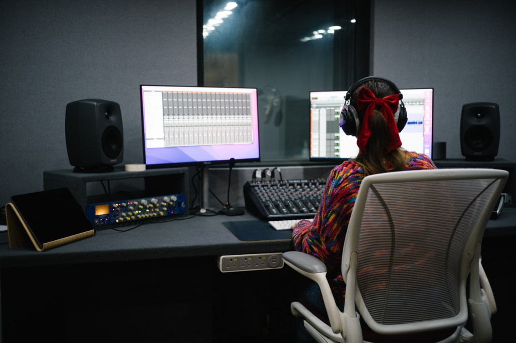 Colleague recording audio in studio
