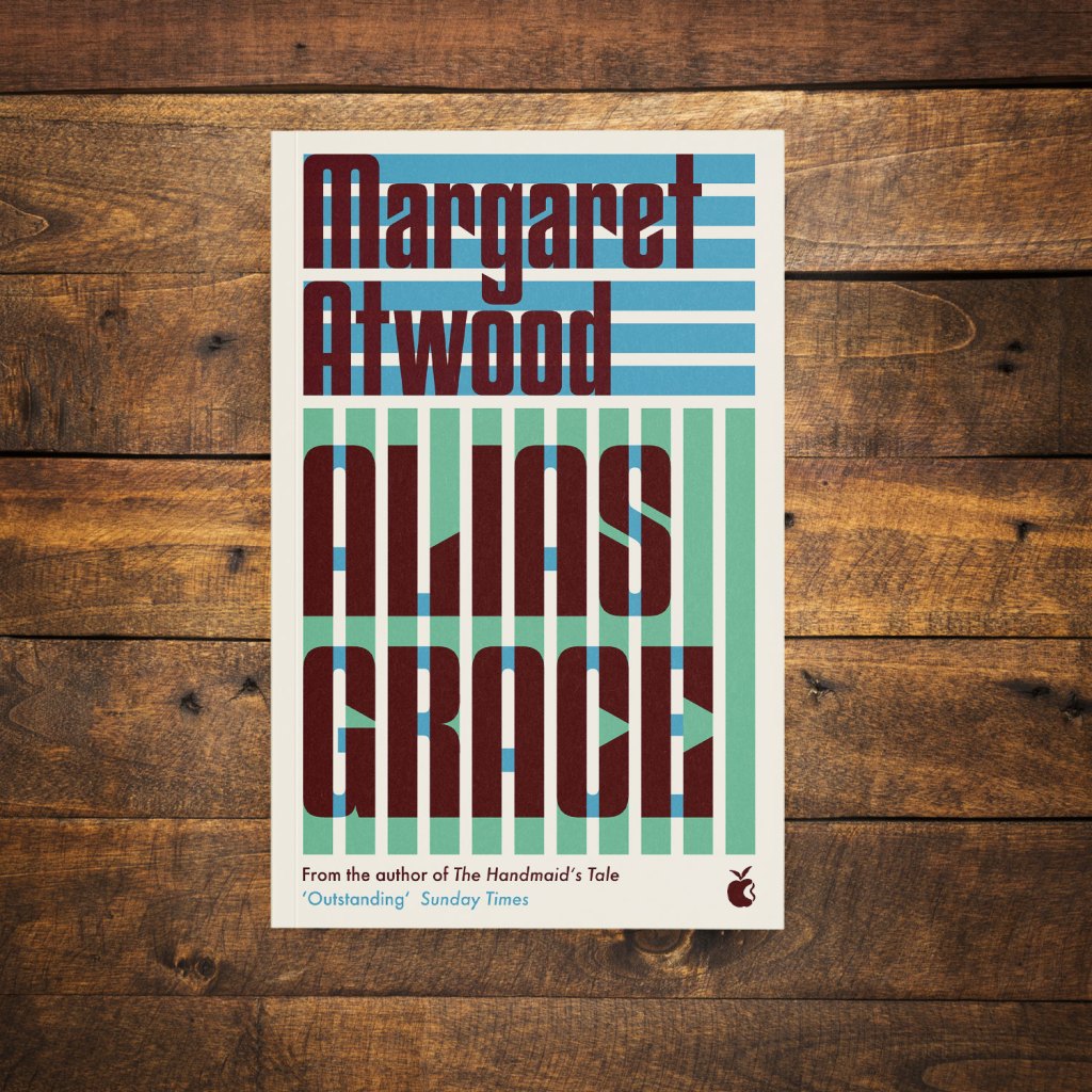 Alias Grace by Margaret Atwood on a dark wood background