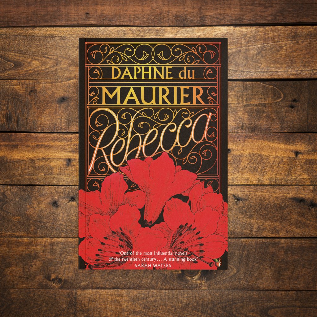 Rebecca by Daphne De Maurier on a dark wood background