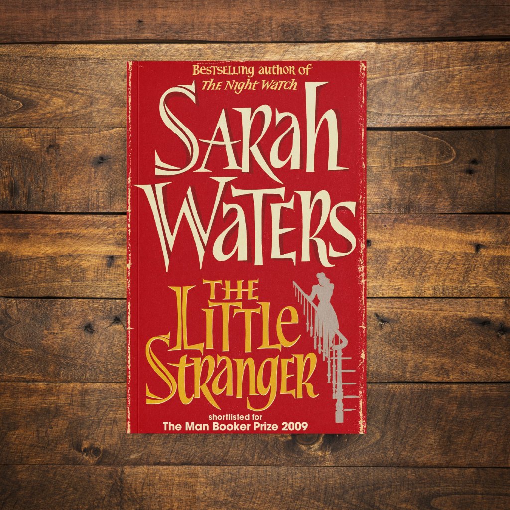 The Little Stranger by Sarah Waters on a dark wood background