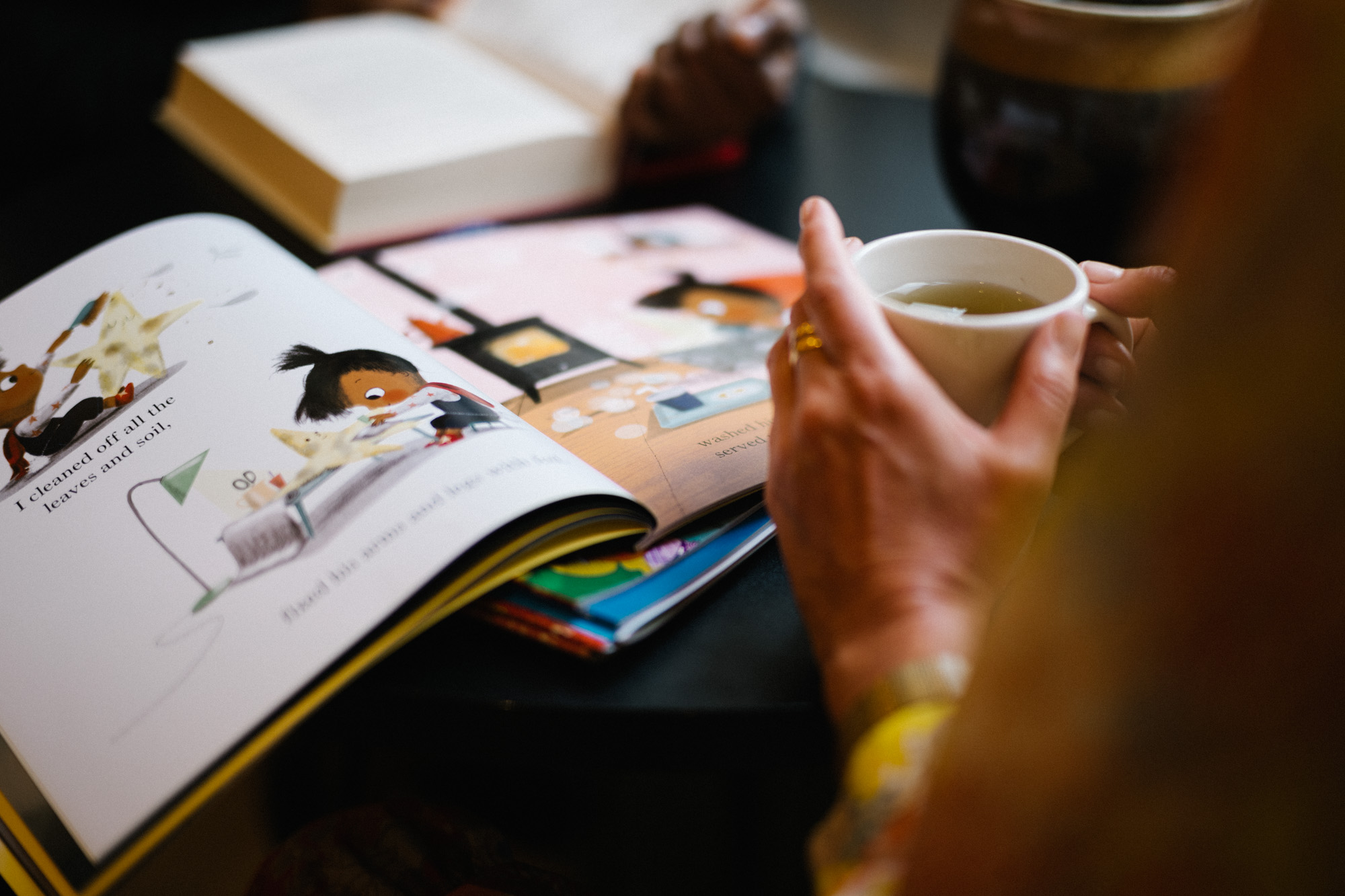 Reading a book with a cup of tea.