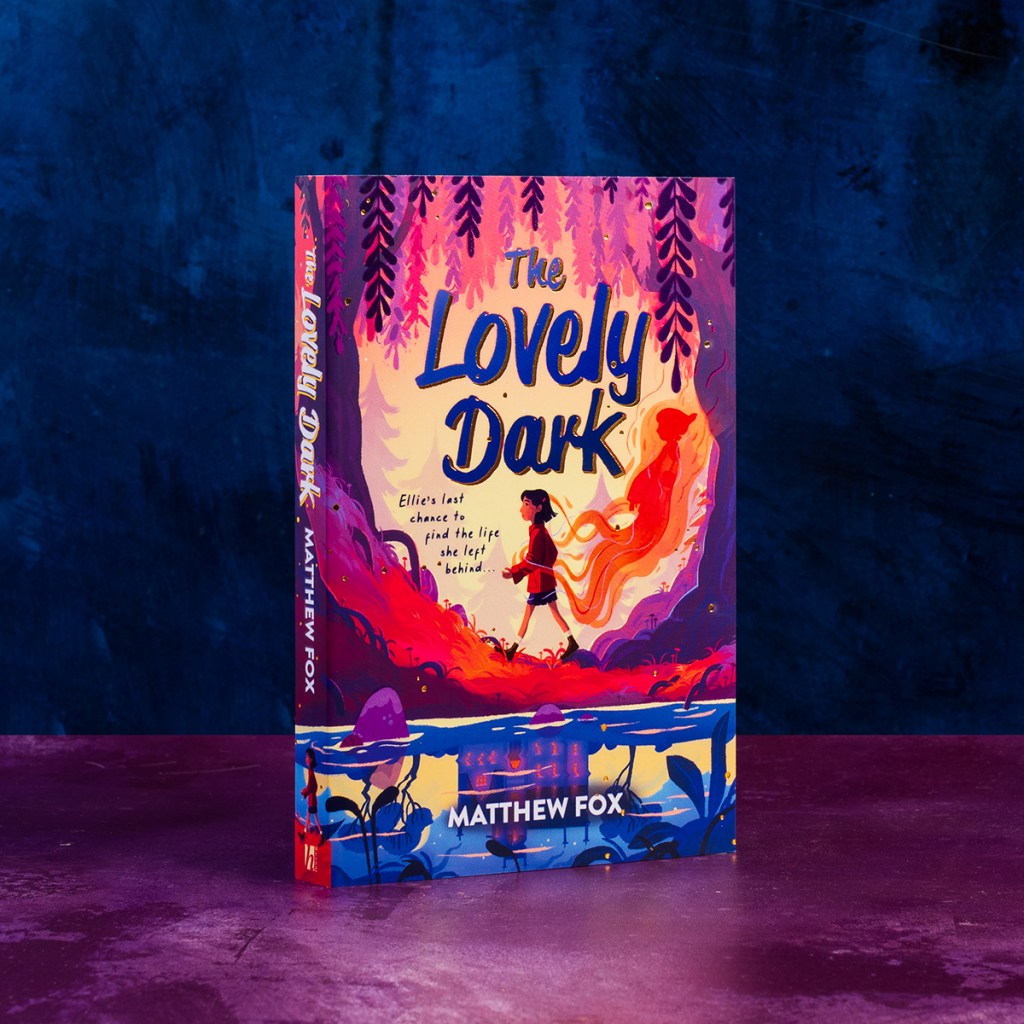 The Lovely Dark book against a purple background
